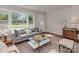 Bright living room featuring a large window, hardwood floors, and neutral-toned furniture at 1147 Norland Rd, Charlotte, NC 28205