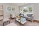 Sunlit living room with hardwood floors, neutral decor, and a large window showcasing the front yard at 1147 Norland Rd, Charlotte, NC 28205