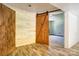 The basement has light-colored wood floors, bright white walls, and a rustic wood barn door at 11861 Nc Hwy 73 E Hwy, Mount Pleasant, NC 28124
