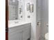 A well-lit bathroom features a gray vanity, a shower with glass door, and framed artwork at 11861 Nc Hwy 73 E Hwy, Mount Pleasant, NC 28124