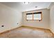 This bedroom features a window for natural light, carpet flooring and neutral colored walls at 11861 Nc Hwy 73 E Hwy, Mount Pleasant, NC 28124