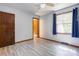 Bedroom with laminate floors, natural light, and blue curtains over the window at 11861 Nc Hwy 73 E Hwy, Mount Pleasant, NC 28124