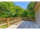 This beautiful backyard deck is spacious and overlooks a verdant lot filled with mature trees at 11861 Nc Hwy 73 E Hwy, Mount Pleasant, NC 28124