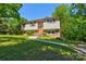 Charming split-level home featuring a well-maintained lawn and mature trees, creating a serene and inviting atmosphere at 11861 Nc Hwy 73 E Hwy, Mount Pleasant, NC 28124