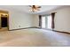 Spacious living room with neutral carpeting, ceiling fan, and glass doors to the backyard at 11861 Nc Hwy 73 E Hwy, Mount Pleasant, NC 28124