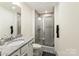 Bathroom features a glass-enclosed shower, a sleek vanity, and stylish tile flooring, creating a clean modern look at 13022 Simoneaux Ln, Charlotte, NC 28277