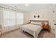Bright bedroom features large windows, neutral tones, and a mounted snowboard, creating a cozy and unique space at 13022 Simoneaux Ln, Charlotte, NC 28277