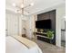 Modern bedroom features a stylish accent wall, floating shelves, and elegant light fixtures for a contemporary aesthetic at 13022 Simoneaux Ln, Charlotte, NC 28277