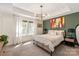 Serene bedroom with a neutral color palette, cozy bed, sheer curtains, and stylish lighting at 13022 Simoneaux Ln, Charlotte, NC 28277