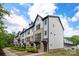 Street view of modern townhomes with brick and gray siding with black trim at 13022 Simoneaux Ln, Charlotte, NC 28277