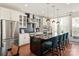 Kitchen with a large island, white cabinets, modern appliances, and counter seating at 13022 Simoneaux Ln, Charlotte, NC 28277