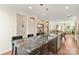 Open-concept living area showcasing a marble island, hardwood flooring, natural light, and seamlessly connected spaces at 13022 Simoneaux Ln, Charlotte, NC 28277