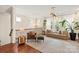 Elegant living area with stylish furniture, a cozy rug, sheer curtains, and abundant natural light at 13022 Simoneaux Ln, Charlotte, NC 28277