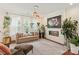 Bright living room featuring a modern fireplace, large windows and indoor plants at 13022 Simoneaux Ln, Charlotte, NC 28277