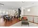 Open-concept living space with dining area, hardwood floors, a cozy chair, and modern decor at 13022 Simoneaux Ln, Charlotte, NC 28277