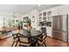 Open concept living space with dining area, bar, and a modern fireplace at 13022 Simoneaux Ln, Charlotte, NC 28277