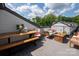 Outdoor patio area set with wooden furniture, perfect for entertaining or relaxing outdoors at 13022 Simoneaux Ln, Charlotte, NC 28277