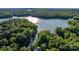 Expansive aerial view of lush forests and a lake, showcasing the home's private waterfront setting at 131 Sierra Woods Dr, Troutman, NC 28166