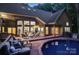 Inviting backyard with a pristine pool, spacious wooden deck, comfortable seating, and well-maintained brick exterior at 131 Sierra Woods Dr, Troutman, NC 28166