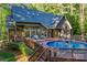 Stunning backyard featuring a sparkling pool, wooden deck, and comfortable outdoor seating at 131 Sierra Woods Dr, Troutman, NC 28166