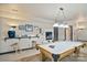 Finished basement with fireplace, billiards table, and built-in bar features for entertainment at 131 Sierra Woods Dr, Troutman, NC 28166