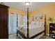 Inviting bedroom with four-poster bed, soft lighting, and access to balcony at 131 Sierra Woods Dr, Troutman, NC 28166