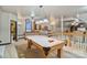 Spacious game room with a pool table and multiple seating areas at 131 Sierra Woods Dr, Troutman, NC 28166