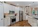 Bright kitchen with stainless steel appliances, white cabinetry, and stylish backsplash at 131 Sierra Woods Dr, Troutman, NC 28166