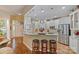 Open-concept kitchen featuring a breakfast bar, stainless steel appliances, and hardwood floors at 131 Sierra Woods Dr, Troutman, NC 28166