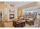 Inviting living room featuring a cozy fireplace, elegant columns, and an open view of the modern kitchen at 131 Sierra Woods Dr, Troutman, NC 28166