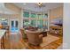 Bright living room with large windows overlooking the pool, complemented by hardwood floors and comfortable seating at 131 Sierra Woods Dr, Troutman, NC 28166