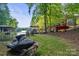 Lakeside property featuring boat dock, chairs, jet ski and serene waterfront views at 131 Sierra Woods Dr, Troutman, NC 28166