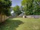 Spacious, fenced backyard with lush green grass and mature trees at 1324 E 35Th St, Charlotte, NC 28205