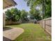 Large, fenced backyard with a storage shed and a patio area at 1324 E 35Th St, Charlotte, NC 28205