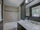Updated bathroom showcasing designer wallpaper, shower over tub, and modern vanity at 1324 E 35Th St, Charlotte, NC 28205