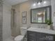 Modern bathroom with shower, custom tiling, and updated vanity at 1324 E 35Th St, Charlotte, NC 28205