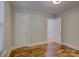 This room features hardwood floors, fresh paint, and an interior door at 1324 E 35Th St, Charlotte, NC 28205