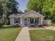 Charming bungalow with a manicured lawn, a quaint porch, and a sidewalk leading to the front door at 1324 E 35Th St, Charlotte, NC 28205