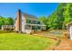 Back exterior view of home with screened-in porch, brick chimney, large backyard and pool area at 1355 Woodrun Ct, Rock Hill, SC 29732