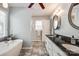 Modern bathroom with a soaking tub, double sinks, and stylish fixtures and decor at 1355 Woodrun Ct, Rock Hill, SC 29732