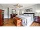 Inviting bedroom with wood floors, ceiling fan, and a large bed with stylish decor at 1355 Woodrun Ct, Rock Hill, SC 29732