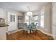 Bright breakfast nook features a modern chandelier, hardwood flooring, and updated furnishings at 1355 Woodrun Ct, Rock Hill, SC 29732