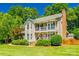 Inviting two-story home featuring a double front porch, brick accents, and a well-manicured lawn at 1355 Woodrun Ct, Rock Hill, SC 29732