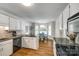 Bright kitchen and breakfast nook features white cabinets, granite countertops, and hardwood flooring at 1355 Woodrun Ct, Rock Hill, SC 29732