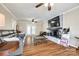 Inviting living room with hardwood floors, brick fireplace, ceiling fan, and French doors leading to the backyard at 1355 Woodrun Ct, Rock Hill, SC 29732
