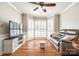 Cozy living room featuring hardwood floors, bay window, comfortable seating, and stylish decor at 1355 Woodrun Ct, Rock Hill, SC 29732