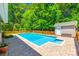 Backyard swimming pool with brick patio, fenced yard, pool house and mature trees at 1355 Woodrun Ct, Rock Hill, SC 29732