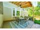 Inviting covered porch with outdoor dining area and views of the backyard and trees at 1355 Woodrun Ct, Rock Hill, SC 29732