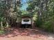 Land with trailer parked under a metal shelter and surrounded by trees at 1355 Woodrun Ct, Rock Hill, SC 29732