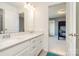 A bright bathroom featuring double sinks and showing sight lines into a bunk room at 15131 Oleander Dr, Charlotte, NC 28278